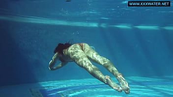Play Kittina swims naked in the swimming pool