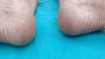 play Close-up of my feet, soles and heels, sunbathing by the river